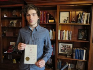 Frank Quigley poses with his certificate of induction into the Phi Sigma Tau philosophy honor society.