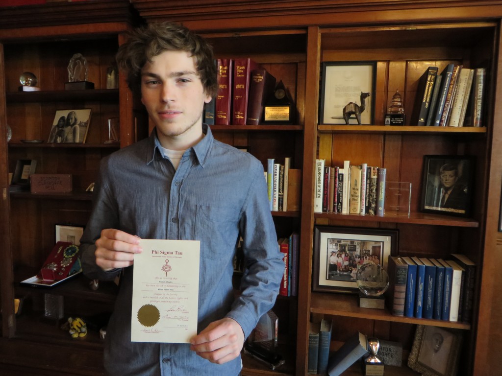 Frank Quigley poses with his certificate of induction into the Phi Sigma Tau philosophy honor society.