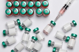 Vaccine bottles and a syringe