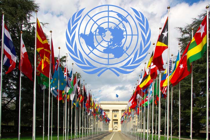 Photo of the national flags gallery at the entrance to UN with the UN logo superimposed above it