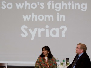 Hayat Alvi and Timothy Hoyt speak onstage during their lecture about United States policy in the Middle East.