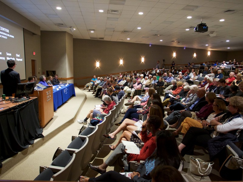 Photograph of a full crowd intently listening to panelists at the Laudato Si event in Bazarksy Lecture Hall.