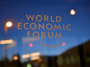 Emblem of the World Economic Forum on a window in Geneva.