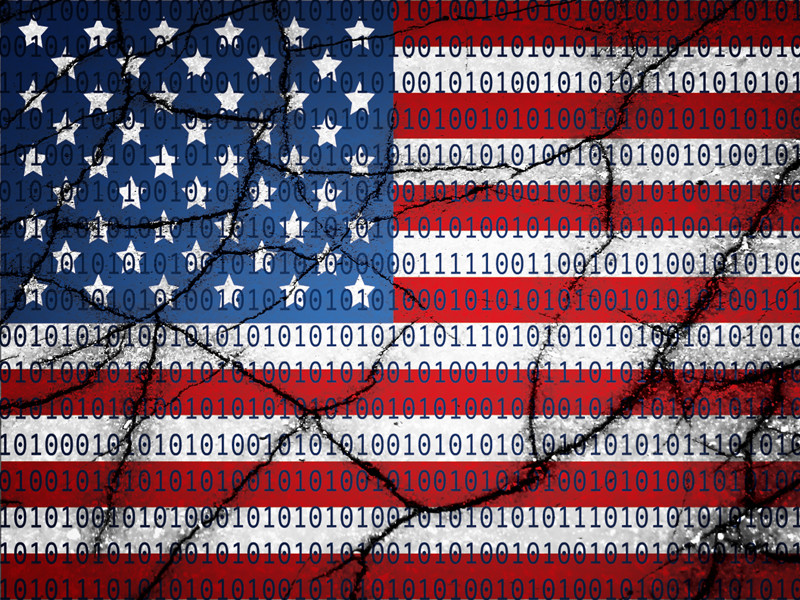 Image of the American Flag covered in ones and zeroes and cracked in pieces to represent a cracked cyber code.