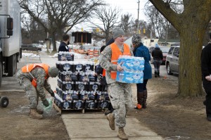 Photograph of soldiers delivering bottled water to citizens of Flint, Michigan.