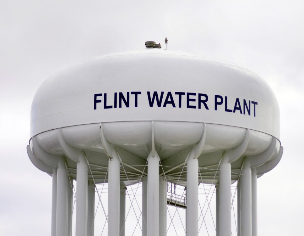 Photograph of a white water plant tower in Flint, Michigan.