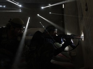 Pulitzer Prize winning image taken by Javier Manzano of Syrian rebel soldiers guarding their position as light streams through bullet holes in a wall.