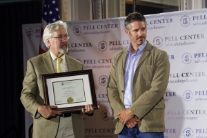 The Providence Journal's G. Wayne Miller presents Javier Manzano with the 2016 Pell Center Prize for Story in the public square as both look away from the camera.