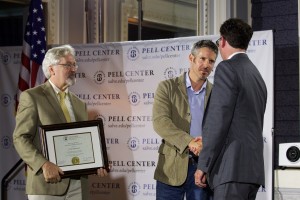 Pell Center Executive Director Jim Ludes shakes hands with Pell Center Prize winner Javier Manzano as the Providence Journal's G. Wayne Miller presents the award.