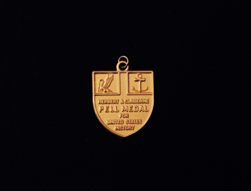 Image of Herbert and Claiborne Pell medal for United States History on a black background.