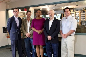 Pell Center employees pose for a photo with Javier Manzano and Raina Kelley on the set of Story in the Public Square.