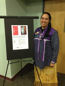 Loren Spears demonstrates poster for her event on Native American Story, Song and Dance