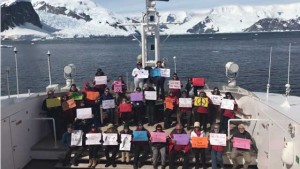 Group demonstrates their posters from Women's March on Washington