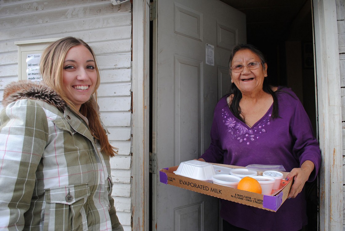 Woman receives a delivery from Meals on Wheels