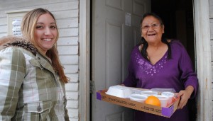 Woman receives a delivery from Meals on Wheels