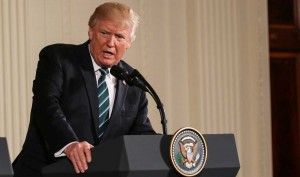 Donald Trump speaks at podium with presidential seal