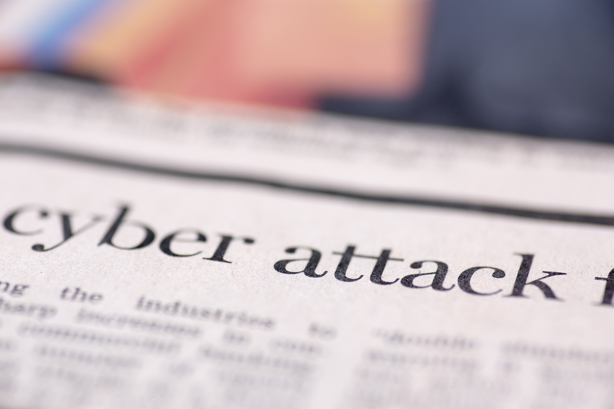 The words "cyber attack" in newspaper print