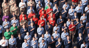 U.S. Navy sailors pledge allegiance to the National Ensign during a Memorial Service.